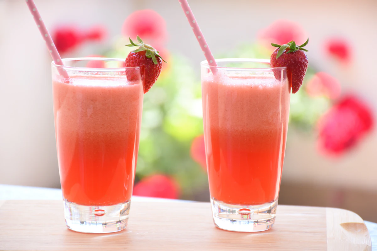 Pink iced fruit drink with strawberries, like Starbucks Energy Refreshers